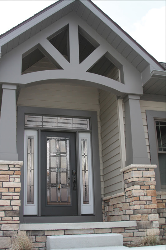 Grey and white entry door with etched windows and sidelites